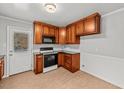 Functional kitchen featuring wood cabinets, modern appliances, and tile backsplash at 118 Tysor Cir, Graham, NC 27253