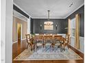 Formal dining room with a modern chandelier, ample seating, and dark accent wall at 1295 Kerr St, Burlington, NC 27215
