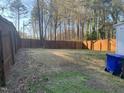 Expansive fenced backyard, perfect for outdoor activities, with a privacy fence and mature trees at 1314 Hearthside St, Durham, NC 27707