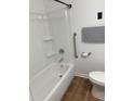 Clean bathroom with a shower-tub combination, grab bar, and modern toilet and towel rack at 1314 Hearthside St, Durham, NC 27707