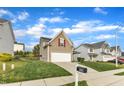 Charming two-story home with a well-manicured lawn, attached garage, and a mailbox in a suburban neighborhood at 1320 Rushing Creek Pkwy, Raleigh, NC 27610
