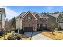 Side view of a brick two-story home with a basketball hoop and manicured landscaping at 1624 Pantego Trl, Cary, NC 27519