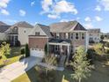 Stunning two-story home with brick and stone accents, a covered porch, and landscaped grounds at 1824 Longmont Dr, Wake Forest, NC 27587