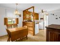 Vintage kitchen with wood cabinets, eat-in dining, and bright natural light at 200 N 9Th St, Erwin, NC 28339