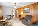 Comfortable living room with wood paneled accent wall and carpet; a serene space to relax at 200 N 9Th St, Erwin, NC 28339