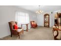 Cozy living room features a bright window, plush carpet, and elegant furniture, creating a welcoming space at 200 N 9Th St, Erwin, NC 28339