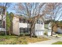 Home featuring a two-car garage and front yard, with mature trees providing shade at 209 Kellerhis Dr, Apex, NC 27502