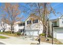 Charming two-story home with a well-manicured lawn, black shutters, and an attached two-car garage at 209 Kellerhis Dr, Apex, NC 27502