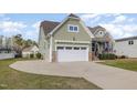 Attached garage with stone accents and a wide driveway, located on a beautifully landscaped lot at 225 Beckwith Ave, Clayton, NC 27527