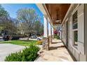 Spacious front porch featuring stone accents and ample space for outdoor seating overlooking the front yard at 2500 Everett Ave, Raleigh, NC 27607