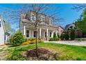 Beautifully landscaped front yard with a tree, green grass, and a charming view of the house at 2500 Everett Ave, Raleigh, NC 27607