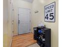 Hallway featuring wood-look floors and a white door with a speed limit sign on the wall at 2800 Trailwood Pines Ln # 301, Raleigh, NC 27603