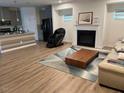 Open-concept living room with hardwood floors, fireplace, and modern decor for comfortable living at 307 King Closer Dr, Cary, NC 27519