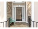 Close-up showcasing the elegant front door entrance with charming bench seating at 316 Pebble Beach Dr, Mebane, NC 27302
