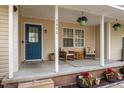 Inviting porch with comfortable seating, potted plants, and a vibrant blue front door, numbered 3490 at 3490 Old Buies Creek Rd, Angier, NC 27501