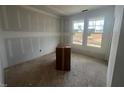 Bright living room with large windows, offering a view of the outdoors and providing an abundance of natural light at 381 Old Fashioned Way, Lillington, NC 27546