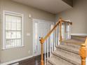 Welcoming foyer featuring hardwood floors, staircase, and a bright window at 382 Tomahawk Dr, Clayton, NC 27520