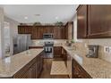 Spacious kitchen boasts granite countertops, stainless steel appliances, and beautiful dark cabinetry at 3925 Massey Pointe Ct, Raleigh, NC 27616