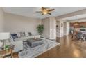 Spacious living room with hardwood floors, a cozy sofa, and a ceiling fan for added comfort at 3925 Massey Pointe Ct, Raleigh, NC 27616