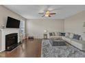 Cozy living room with fireplace, ceiling fan, and plush rug, creating a comfortable atmosphere at 3925 Massey Pointe Ct, Raleigh, NC 27616