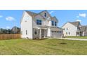 Lovely two-story home featuring a manicured lawn and an attached two car garage at 4104 Ralph Holt Ct, Snow Camp, NC 27349