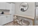 Kitchen breakfast bar features white marble countertop and three barstool chairs at 4408 Poplar Dr, Raleigh, NC 27610