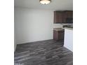 Eat-in kitchen with dark cabinets and black appliances at 5016 Gailardia Dr, Zebulon, NC 27597