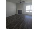 Bright living room with fireplace, ceiling fan, and wood-look floors at 5016 Gailardia Dr, Zebulon, NC 27597