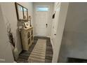 Neutral foyer with wood-look flooring and decoratively furnished with cabinet and lamp at 5045 Kota St, Raleigh, NC 27610