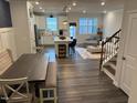 Open floor plan with a modern kitchen, dining space, and cozy living room area at 5045 Kota St, Raleigh, NC 27610