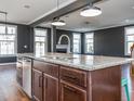 Open kitchen featuring granite counters, stainless steel appliances, and a large island with eat-in seating at 5347 Cypress Ln, Raleigh, NC 27609