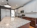 Spacious kitchen features granite counters, stainless steel appliances and ample cabinet space at 5347 Cypress Ln, Raleigh, NC 27609