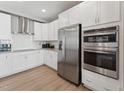 Modern kitchen features stainless steel appliances, white cabinets, and granite countertops for a sleek and clean look at 600 Hedrick Ridge Road # 112, Cary, NC 27519
