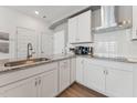 Well lit kitchen featuring stainless steel appliances, white cabinets, and granite countertops at 600 Hedrick Ridge Road # 112, Cary, NC 27519