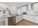 This kitchen features stainless steel appliances, white cabinets, granite countertops and great lighting at 600 Hedrick Ridge Road # 112, Cary, NC 27519
