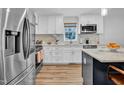 Modern kitchen with stainless steel appliances, marble countertops, and white cabinetry at 602 Gray Ave, Durham, NC 27701