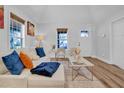 Cozy living room with an off-white couch, wood-look flooring, and neutral decor, creating a welcoming atmosphere at 602 Gray Ave, Durham, NC 27701