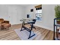 Minimalist office space with a glass desk, laminate flooring, and ample natural light for a productive workspace at 602 Gray Ave, Durham, NC 27701