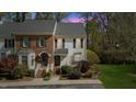 Charming townhouse with brick and siding exterior and manicured front yard at dusk at 6750 Olde Province Ct, Raleigh, NC 27609