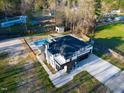 Aerial view of modern home with in-ground pool, spacious yard, and surrounding greenery at 73 Clyde Pearce Rd, Zebulon, NC 27597