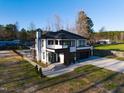 Modern home aerial view featuring sleek design, an in-ground pool, and black framed windows at 73 Clyde Pearce Rd, Zebulon, NC 27597