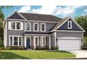Charming home featuring a two-car garage, covered porch, and a harmonious blend of colors and architectural details at 740 Portland Rose Dr, Knightdale, NC 27545