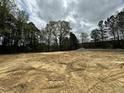 Cleared land ready for development or building, featuring mature trees surrounding the property at 740 Portland Rose Dr, Knightdale, NC 27545
