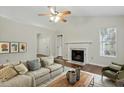 Inviting living room showcasing a fireplace, comfortable seating, modern decor, and hardwood flooring at 815 Riverbark Ln, Durham, NC 27703