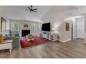 Spacious living room featuring a fireplace, wood flooring and large windows offering outdoor views at 9512 Anson Grove Ln, Raleigh, NC 27615