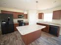 Modern kitchen featuring black appliances, granite countertops, and a functional island at 10 Chaney Ln, Louisburg, NC 27549