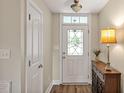 Inviting entryway features a decorative glass door, pretty lamp, and beautiful flooring at 100 Hillside Village Dr, Louisburg, NC 27549