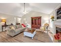Spacious living room with vaulted ceilings, lots of seating and a cozy fireplace at 100 Hillside Village Dr, Louisburg, NC 27549