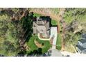 Expansive property featuring a well-maintained lawn, patio, and lush surrounding foliage at 1009 High Trail Ct, Wake Forest, NC 27587