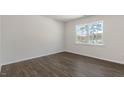 Spacious bedroom showcasing a large window and luxury vinyl plank flooring at 1100 Ursa Major Ct, Wendell, NC 27591